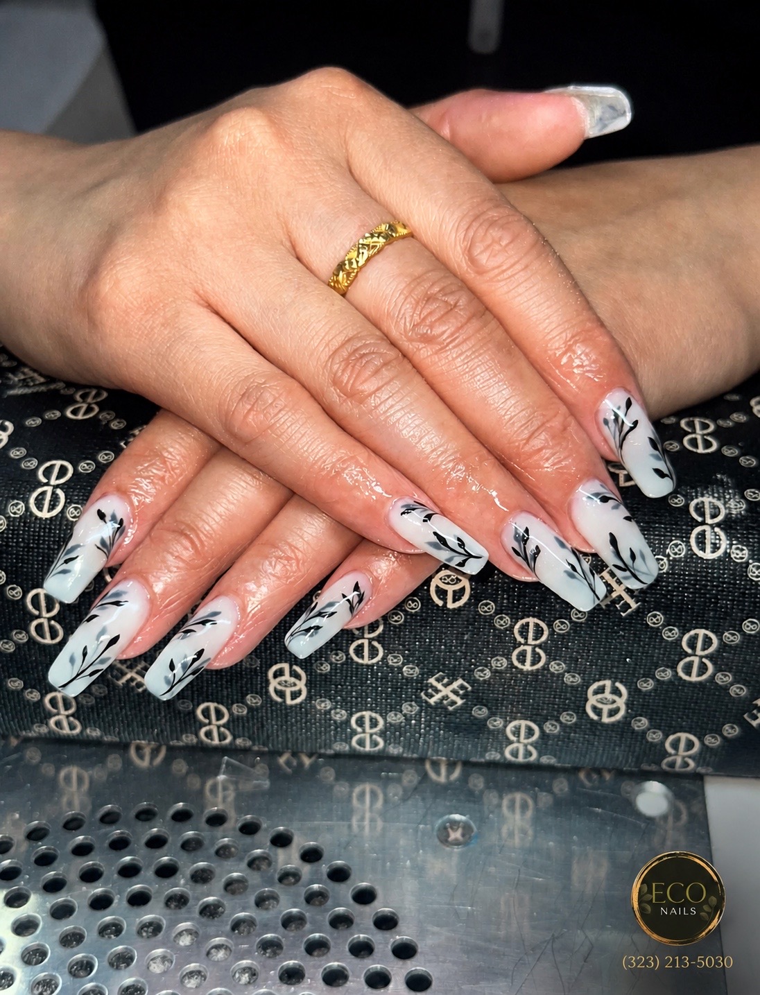 White nails with black leaf nail art